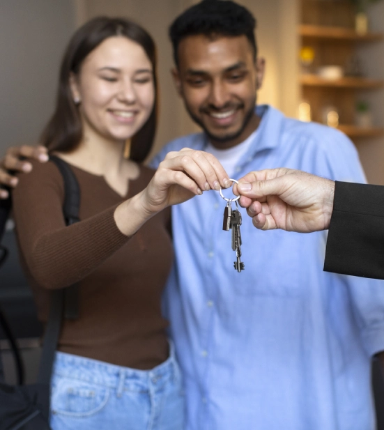 Alt A mortgage lender handing over the key to a house to a happy couple