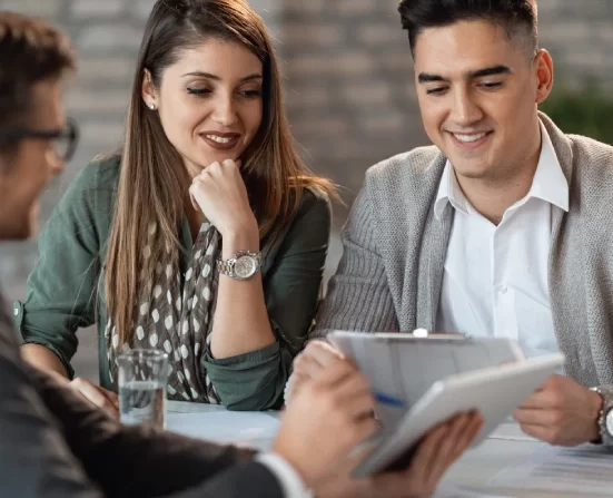 Alt A mortgage lender showing a happy couple mortgage plans on a tablet