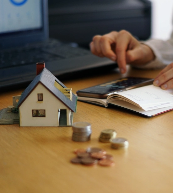 Alt A person calculating mortgage rates on a mobile phone