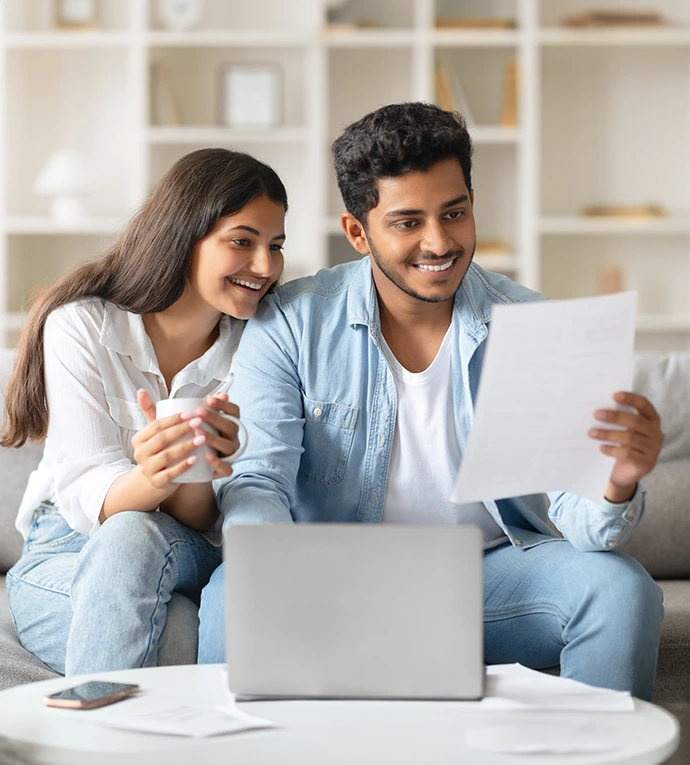 A happy couple looking at a document